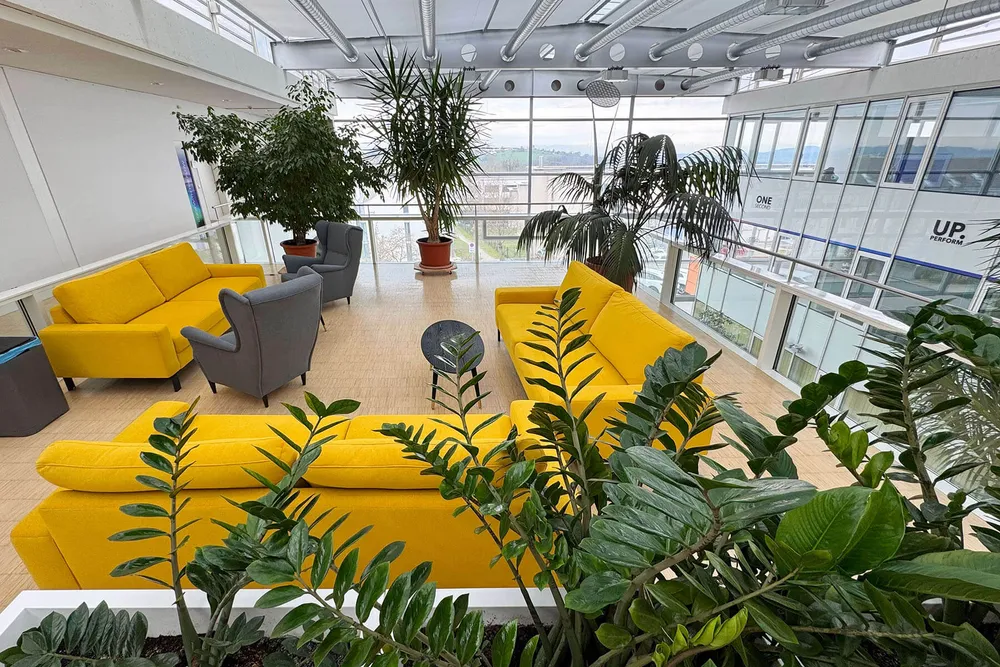 The lounge seen from above, looking out through a full-height window over the hills beyond Hagenberg.